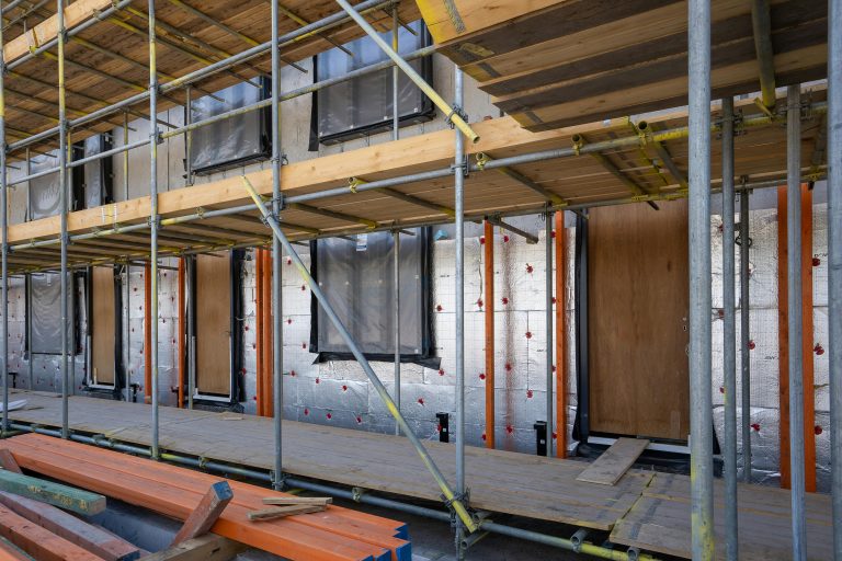 Scaffolding installed around a residential building under construction